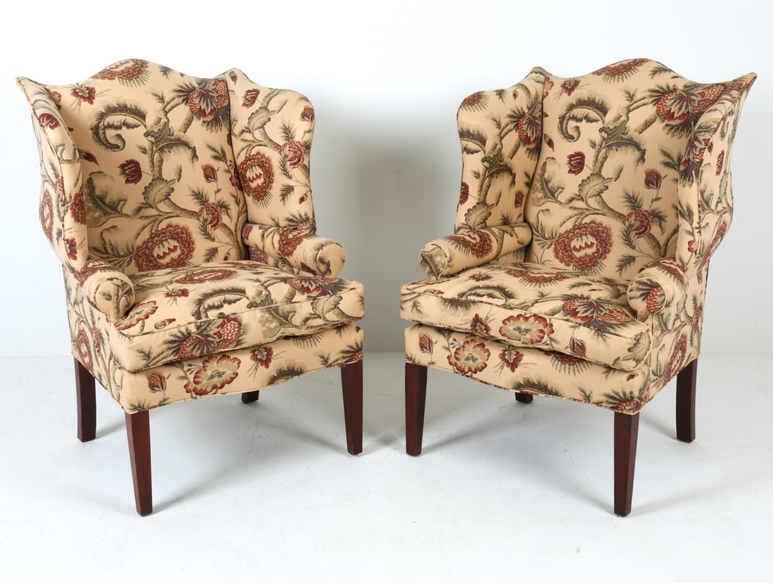PAIR OF WINGBACK LOUNGE CHAIRS: Wingback lounge chairs with patterned fabric upholstery. 20th century. Dimensions:: H 43" x W 30" x D 27.5" x Sh 18.5". Conditions: Wear consistent with age and use including dings and rubs to feet.