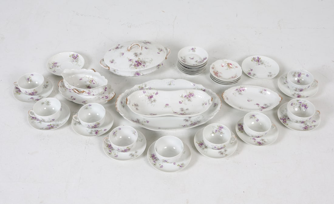 THEODORE HAVILAND LIMOGES PORCELAIN SERVICE: Marked under bases. Dimensions: Covered Dish H 6" x W 11.5" x D 8". Large Platter L 14" x W 11". Condition: Repaired dish. Missing handle to one teacup. Wear consistent with age and use.