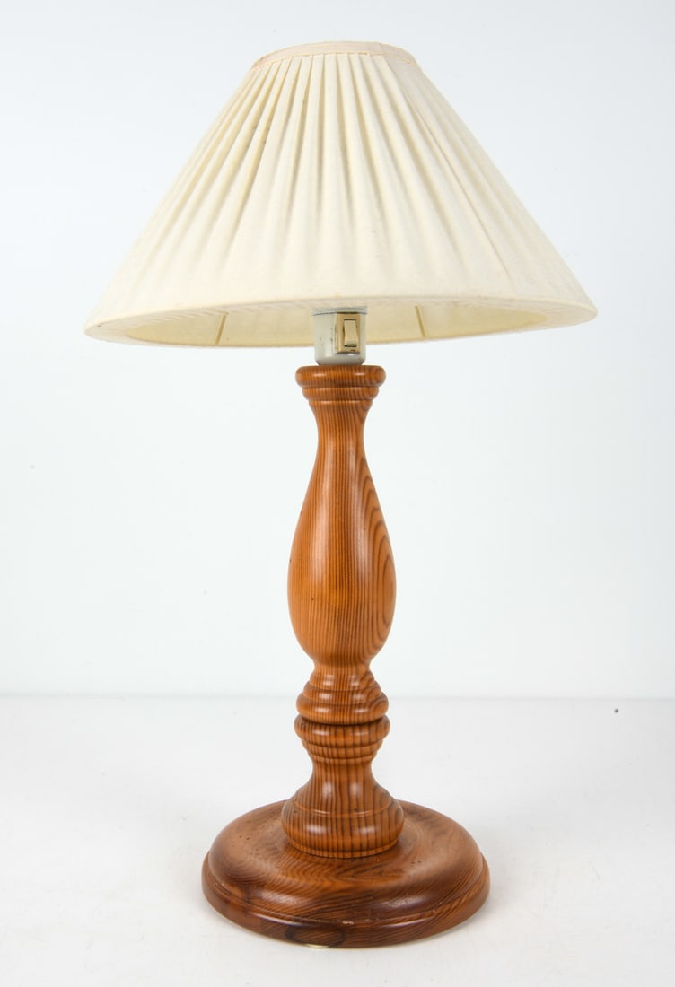 SWEDISH PINE TABLE LAMP C. 1970S: Pine table lamp with fabric shade. Sweden, circa 1970s. Dimensions: H 23.5" x Dia. 13.75". Condition: Wiring untested, European plug. Minor scuffs, minor paint loss to socket. Wear consistent with age