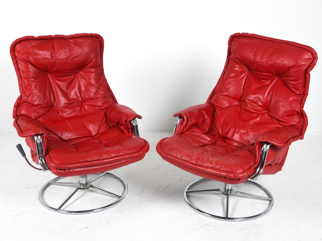 PAIR OF SWEDISH CHROME & LEATHER SWIVEL ARMCHAIRS: Chrome-plated metal and leather upholstery. Sweden, circa 1970s. Dimensions: H 38" x W 30" x D 27" Condition: Wear consistent with age and use. Minor cracks and creasing to upholstery. D50