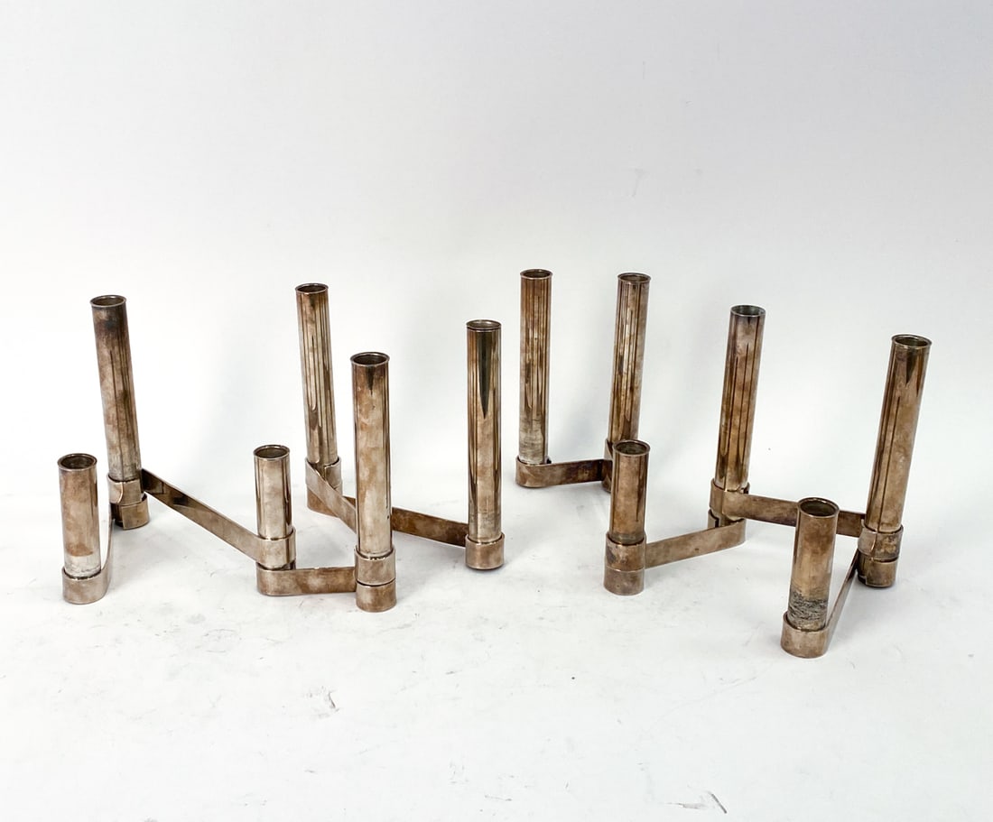 PAIR OF GIO PONTI "ANTIBES" CANDLE HOLDERS C. 1956: Pair of silver plated candle holders designed by Gio Ponti for Lino Sabattini Italy in 1956 for the Antibes collection. Marked on surface. Dimensions: H 8" x W 11" x D 2" Condition: Patina, oxidizing