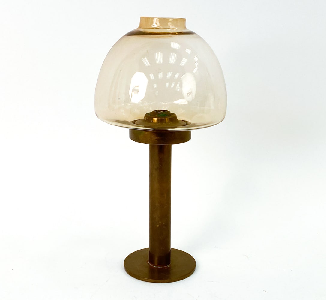 HANS-AGNE JAKOBSSON SWEDISH BRASS CANDLE LANTERN: Scandinavian candle lantern by H. A. Jakobsson, featuring lightly smoked glass shade and brass stem. Label underneath. Sweden, circa 1960's. Dimensions: H 14" x W 7" Condition: Untested. Few small sca