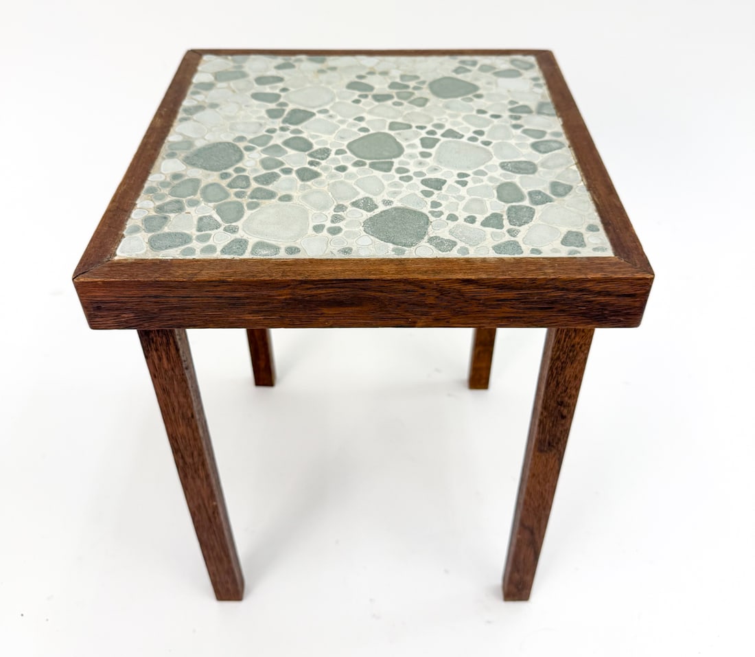 VINTAGE DANISH TEAK WITH TILE TOP SIDE TABLE: Featuring a mosaic top made of light-colored tumbled "sea glass" style pieces set in a white base. Apparently unmarked. Dimensions: H 17" x W 13.5" x D 13.5" Condition: Stress marks to joinery, soling