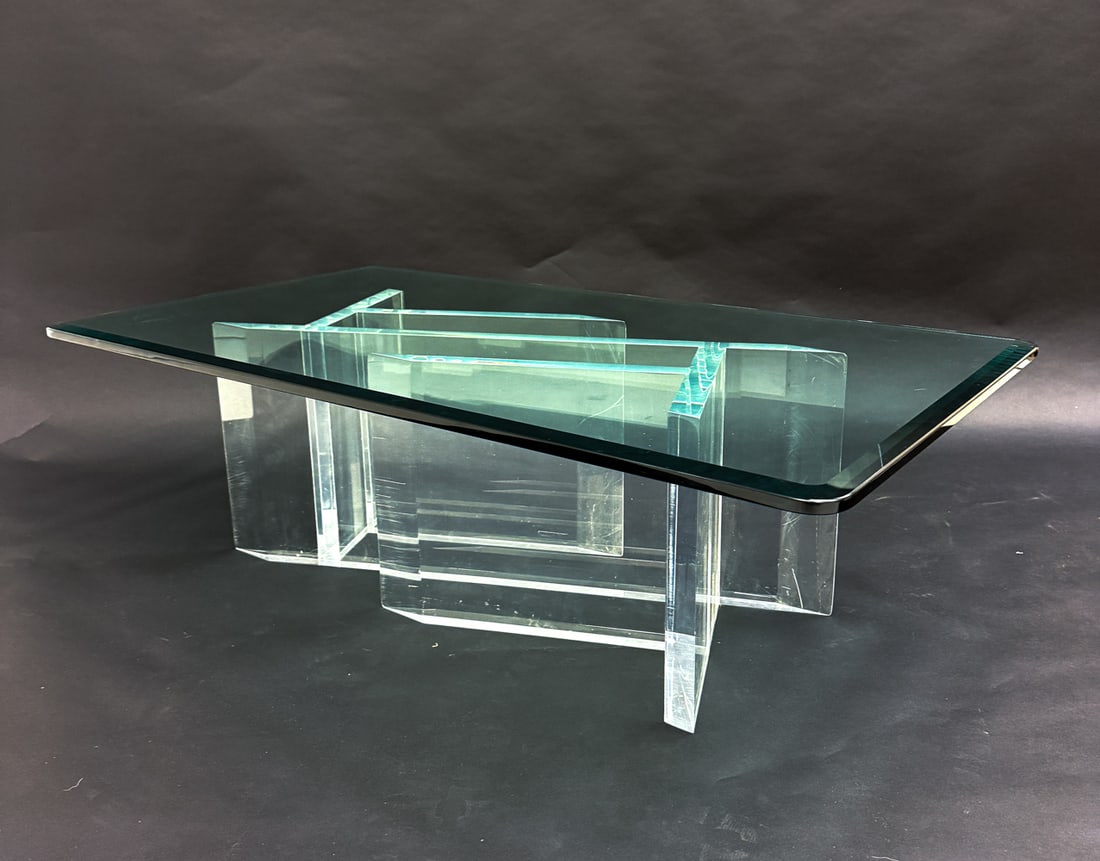 CONTEMPORARY LUCITE & GLASS COFFEE TABLE: Featuring a sculptural lucite base with a rectangular glass top. Unmarked. Dimensions: H 16" x W 52" x D 28" Condition: Scratches, scuffs and marks to base and top consistent with age and use. Small n