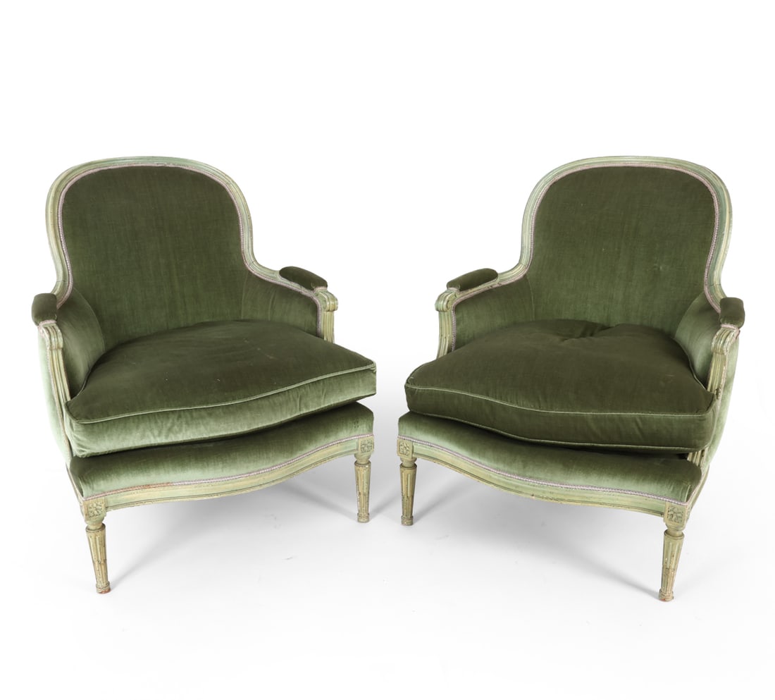 PAIR LOUIS XV STYLE VELOUR "BERGERE" LOUNGE CHAIRS: Carved wood frame with light-colored paint, and upholstered in deep green velour. Apparently unmarked. Dimensions: H 37" x W 30" x D 26" x SH 16" Condition: Few nicks and scratches to armrests and leg