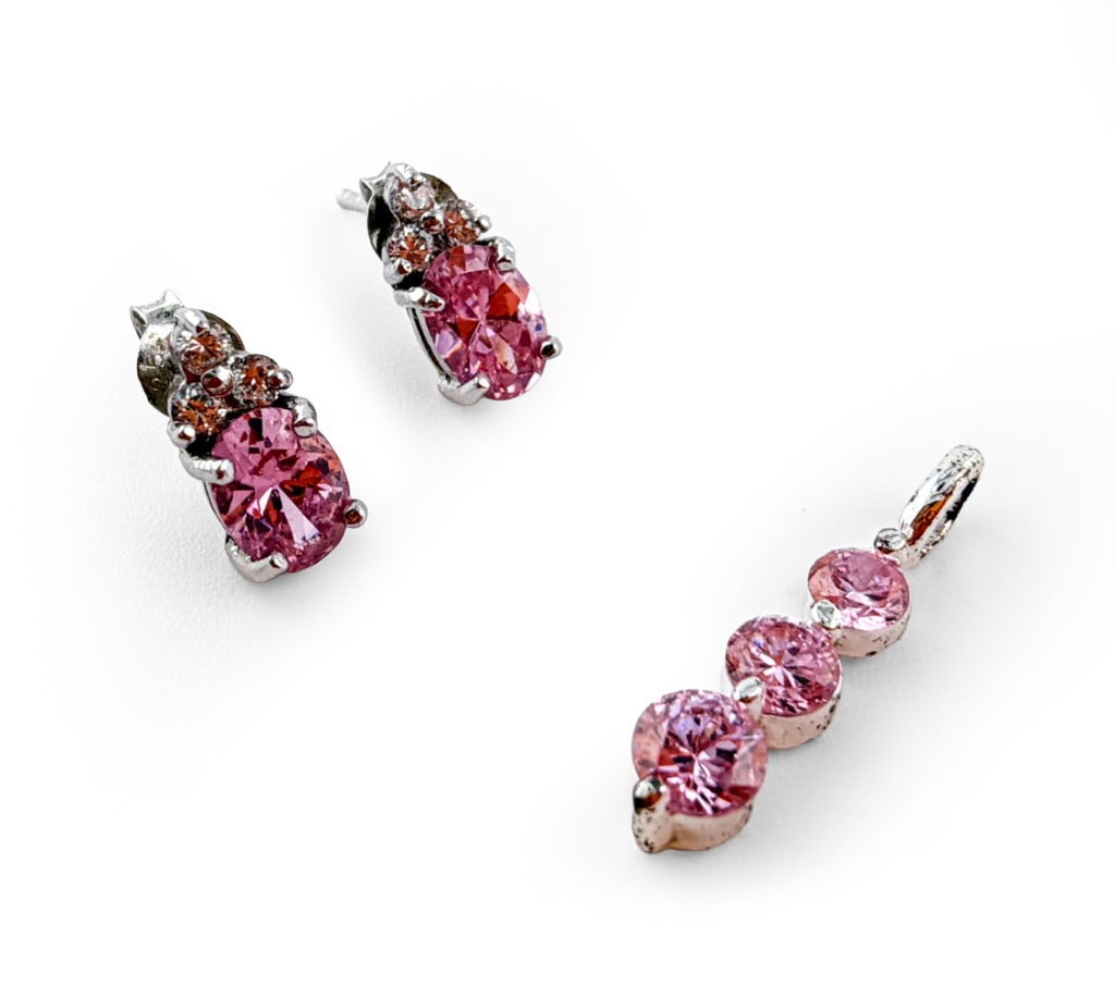 PAIR STERLING SILVER EARRINGS & MATCHING PENDANT: Pair of sterling earrings with faux diamonds and pink stones, with matching sterling pendant featuring pink stones. Earrings marked FAS 925, pendant marked 925. Total weight: 1.9dwt Dimensions: (Penda
