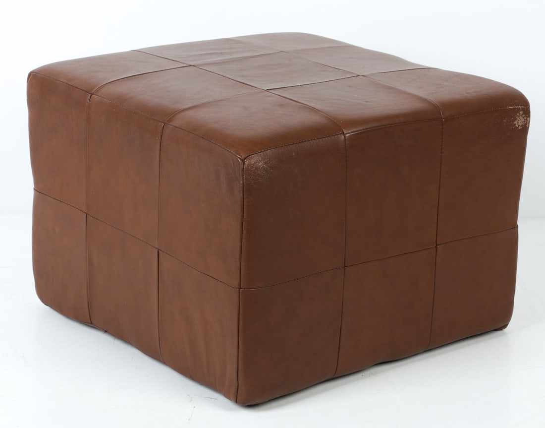 STYLE OF DE SEDE LEATHER OTTOMAN STOOL C. 1960S: Ottoman in tan leather patchwork upholstery. Scandinavian, circa 1960s. Dimension: H 12.25" x W 18.25" x D 18". Conditions: Wear consistent with age and use. scuffs to leather. DMW188