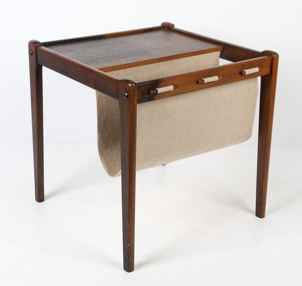 BRDR FURBO DANISH TEAK MAGAZINE HOLDER C. 1960S: Teak magazine holder with canvas sling. Tagged underneath. Denmark, circa 1960s. Dimensions: H 18" x W 17.75" x D 17.75". Condition: Minor scuffs to wood, sun fading to surface. wear consistent with a