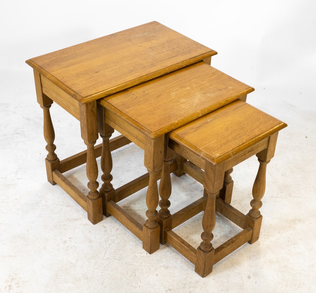 STYLE OF HENNING KJAERNULF OAK NESTING TABLES: Set of (3) oak nesting tables. Denmark, circa 1970s. Dimensions: Largest H 19.75" x W 21.25" x D 13". Condition: Wear consistent with age and use including rubs and dings, minor water spots present. D