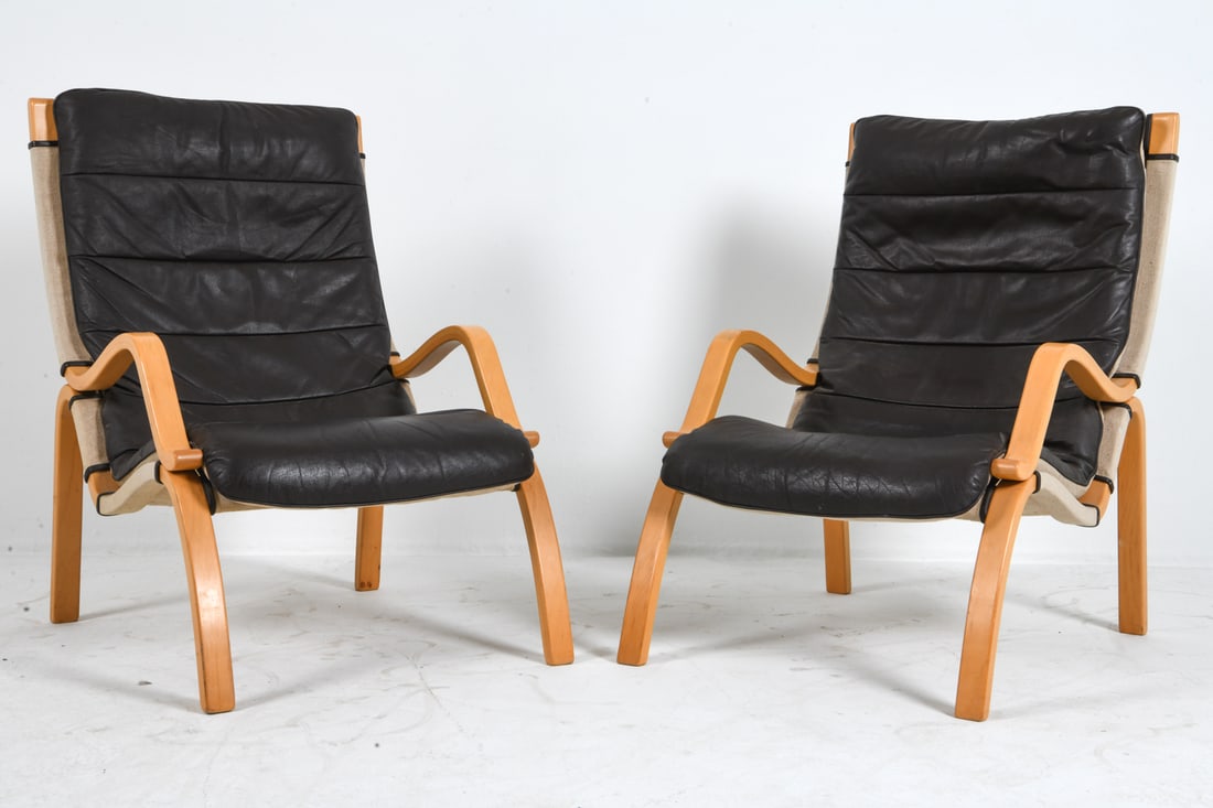 PAIR OF OSTERGAARD STYLE BEECH & LEATHER CHAIRS: Beech bentwood frames with brown leather cushions in Finn Ostergaard design style. Denmark, circa 1970s. Dimension: H 36.75" x W 24.75" x 30.5" x Sh 14.5". Conditions: Wear consistent with age and use