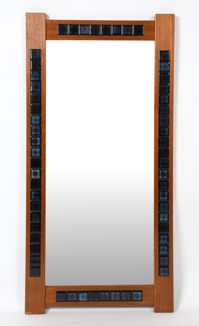 DANISH TEAK & CERAMIC TILE WALL MIRROR C. 1960S: Teak wall mirror with blue ceramic tiles inlaid to frame. Denmark, circa 1960s. Dimensions: H 41.75" x W 20.75". Condition: Wear consistent with age and use. DMT171