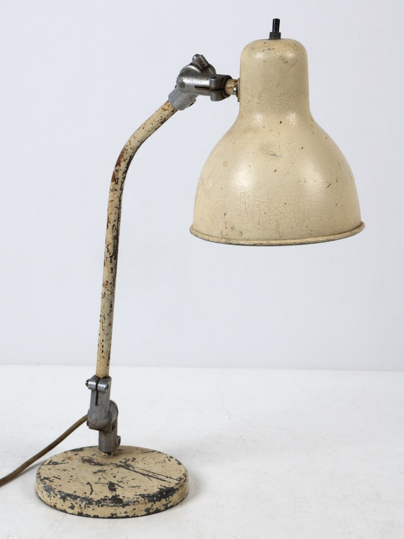 SCANDINAVIAN STEEL DESK LAMP C. 1950S: Desk lamp in white painted finish. Adjustable lamp head. Scandinavian, circa 1950s. Dimensions: H 18.75" x W 5.5" x D 14.25". Conditions: Wiring untested. Wear consistent with age and use including di