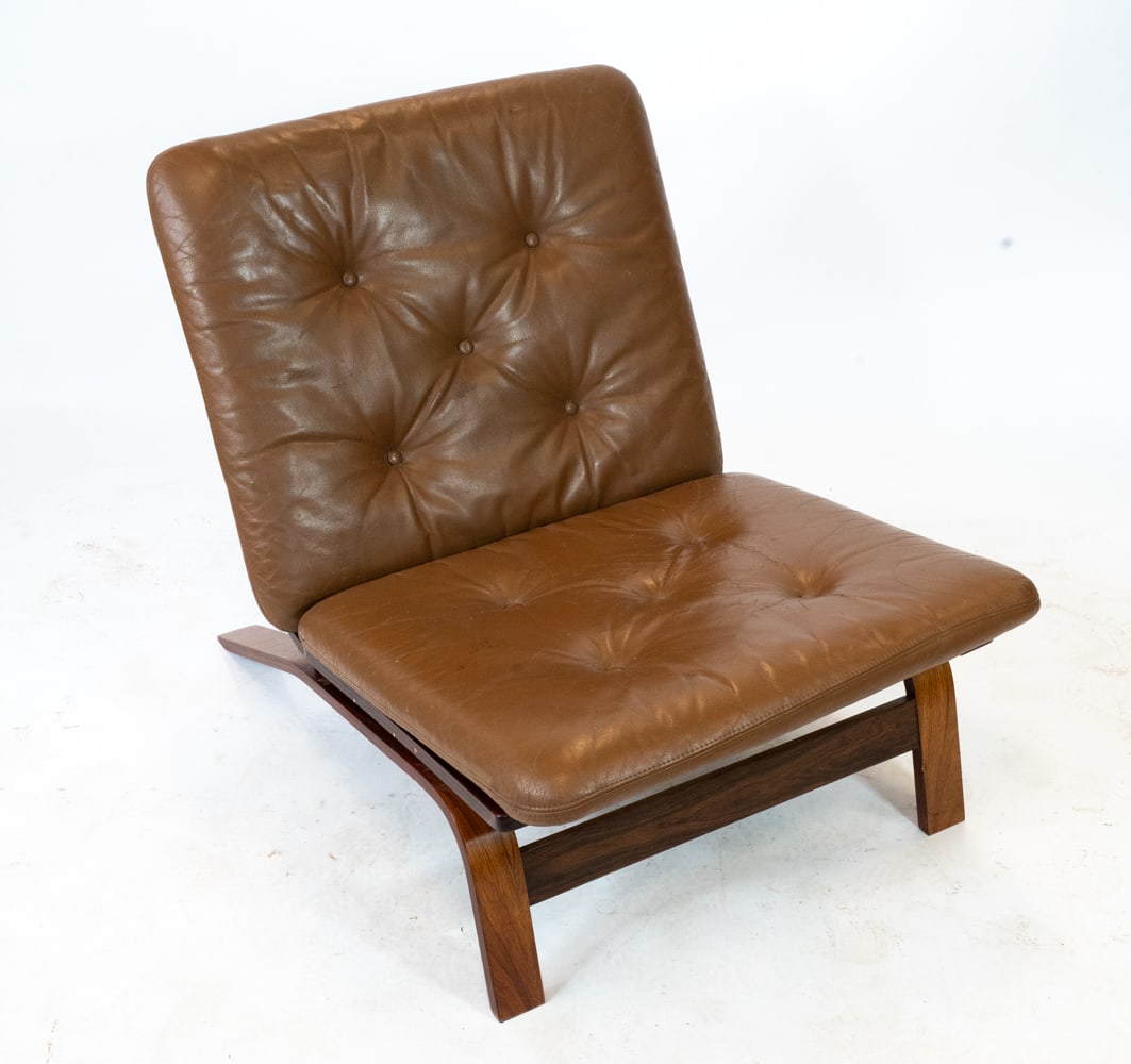 MANNER OF SOLHEIM ROSEWOOD & LEATHER LOUNGE CHAIR: In the manner of Elsa & Nordahl Solheim for Rybo Rykken. Rosewood bentwood frame with brown leather cushion. Norway, circa 1960s. Dimensions: H 25.75" x W 25" x D 31" x Sh 13". Conditions: Wear consis