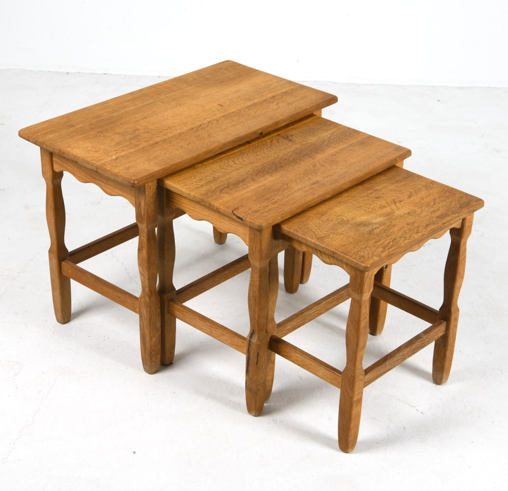 ATTR. KJAERNULF DANISH OAK NESTING TABLES C. 1970S: Set of (3) oak nesting tables. Denmark, circa 1970s. Dimensions: Largest H 19" x W 25" x D 14". Condition: Minor scuffs and rubs, wear consistent with age and use. DMT094