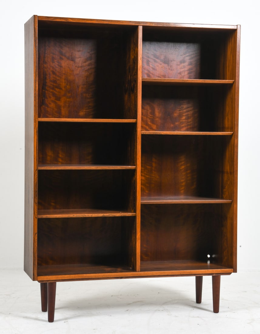 POUL HUNDEVAD DANISH ROSEWOOD BOOKCASE C. 1960S: Adjustable shelves. Stamped to back. Denmark, circa 1960s. Dimensions: H 59" x W 42" x D 12". Condition: Few holes cut out into back. Wear consistent with age and use. DMT061
