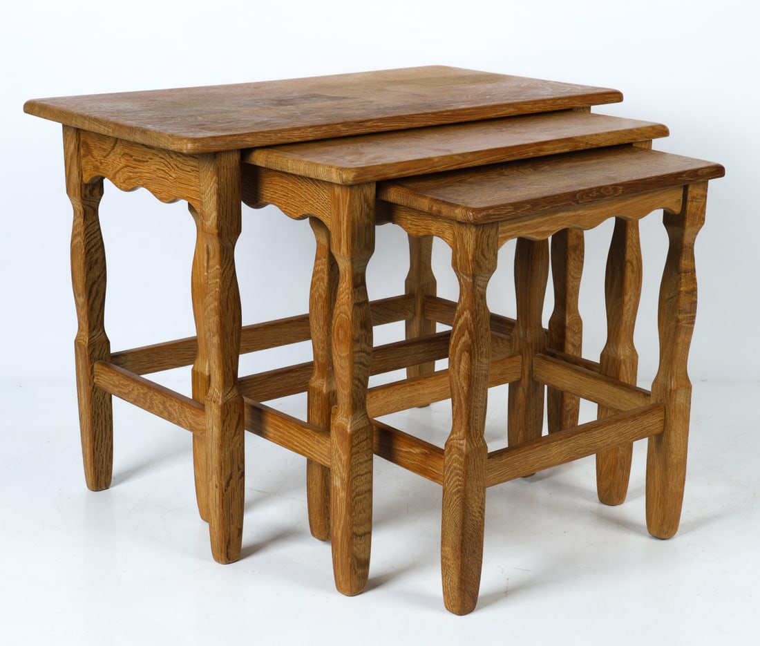 ATTR. HENNING KJAERNULF OAK NESTING TABLES C.1970S: Set of (3) oak nesting tables in graduating sizes. Denmark, circa 1970s. Dimensions: Largest H 19" x W 25.5" x D 14". Condition: Wear consistent with age and use, including faint dings and rubs, water