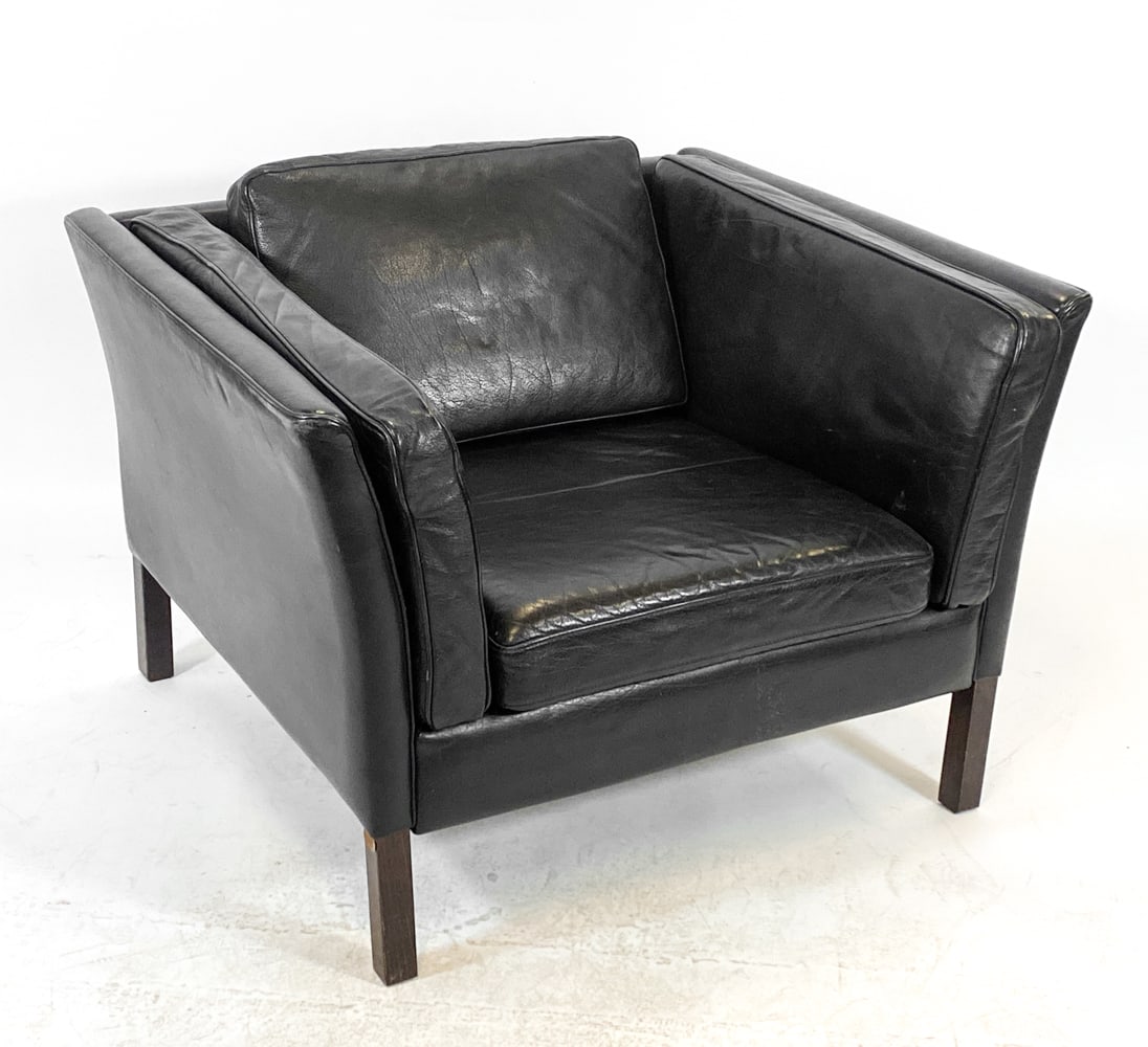 STOUBY DANISH LEATHER LOUNGE CHAIR C. 1970S: Marked to fabric lining and leg frame. Leather lounge chair with beech legs. Denmark, circa 1970s. Dimensions: H 25.5" x W 36.5" x D 31.5" x Sh 15". Conditions: Wear consistent with age and use, inclu