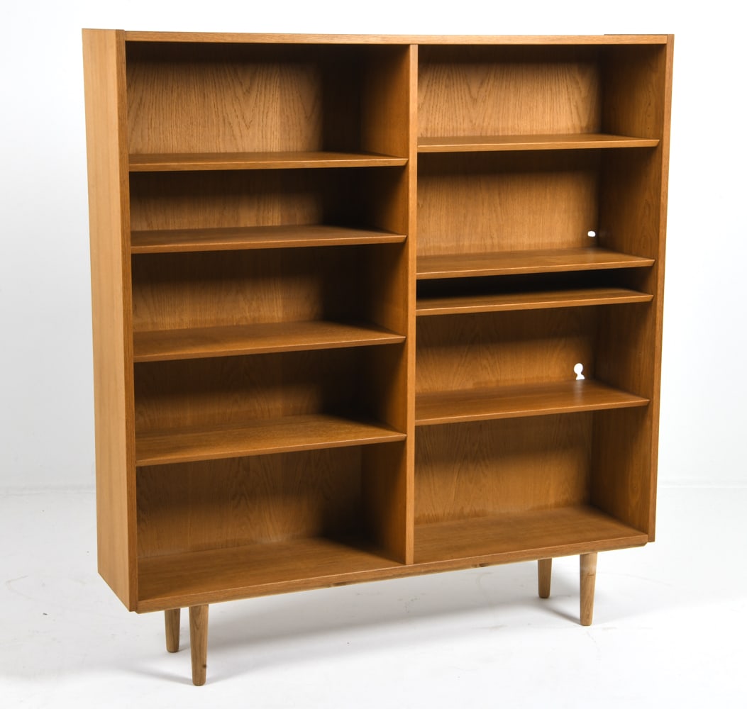 ATTR. CARLO JENSEN DANISH OAK BOOKCASE C. 1960S: Adjustable shelves. Denmark, circa 1960s. Dimensions: H 59" x W 54.5" x D 12.25". Condition: Cut out to back. Wear consistent with age and use. DMU226