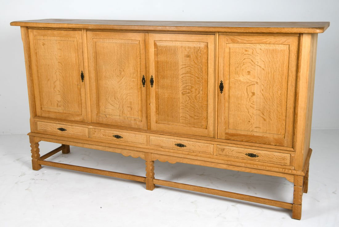KJAERNULF STILMOBLER DANISH OAK SIDEBOARD C. 1970S: Key included. Adjustable shelves. Felt lined drawers. Tagged on the back. Denmark, circa 1970s. Dimensions: H 47.25" x W 88.5" x D 19.5" Condition: Wear consistent with age and use, including rubs and