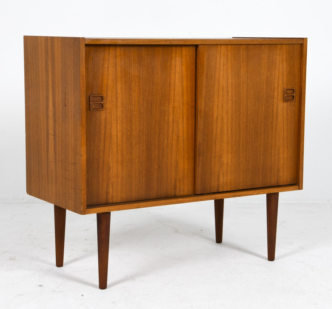 STYLE OF EJM SKIVE DANISH TEAK CABINET C. 1960S: Adjustable shelf with sliding door. Denmark, circa 1960s. Dimensions: H 31.25" x W 34.75" x D 16.5" Condition: Wear consistent with age and use consistent with age and use including rubs and dings. F0