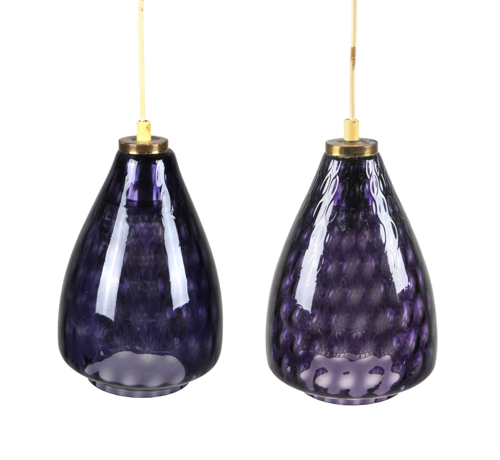 STYLE OF JO HAMMERBORG GLASS PENDANT LIGHTS: Purple glass outer shades with clear glass inner shades. Denmark, circa 1960s. Dimensions: H 10.5" x Dia. 6.5". Condition: Wiring untested. Oxidation to brass cap. Wear consistent with age and use.