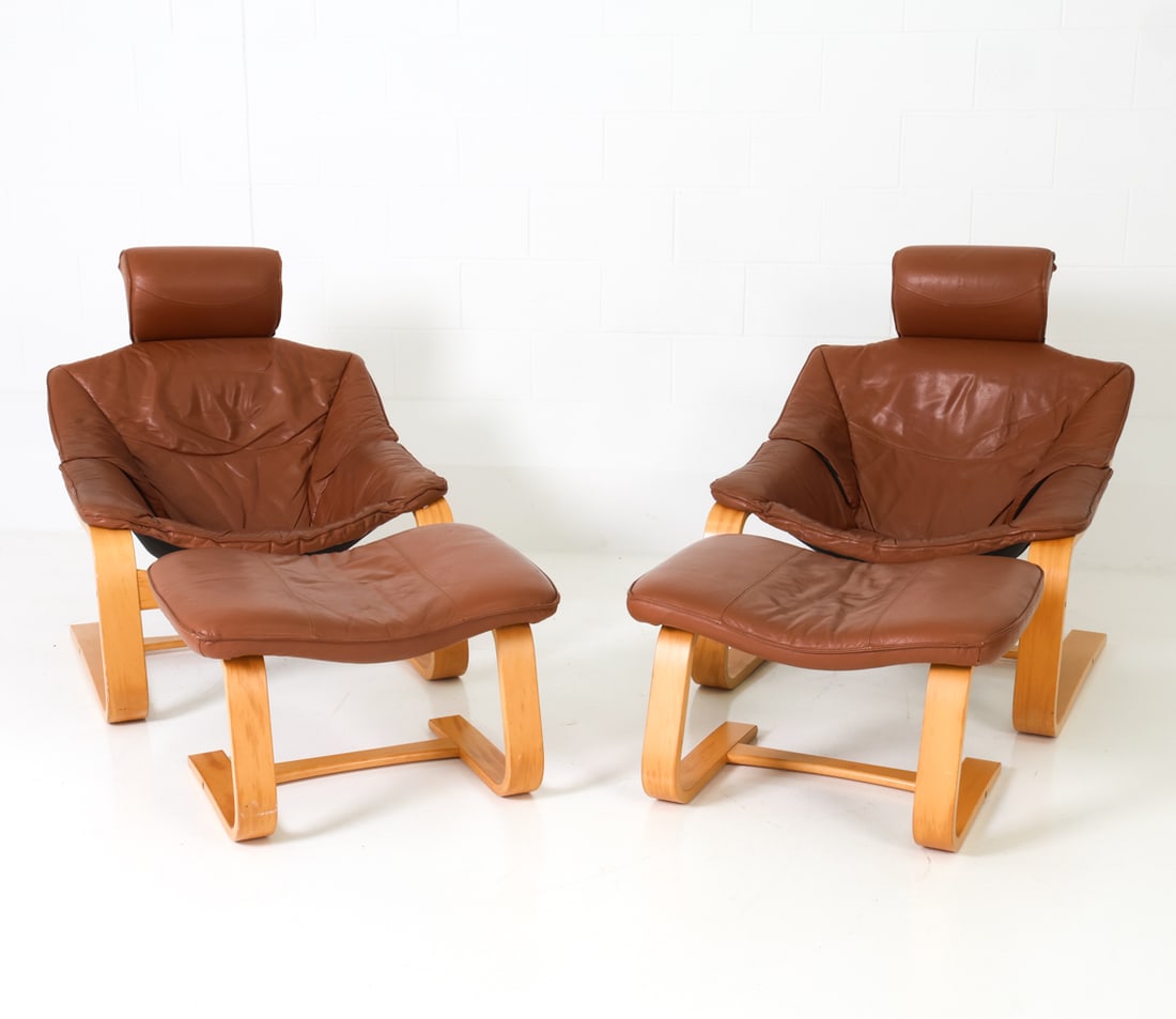 PAIR AKE FRIBYTTER STYLE LOUNGE CHAIRS W/ OTTOMANS: Two bentwood beech frame and leather cushions lounge chairs, with ottomans, in the style of Ake Fribytter for Nelo Mobelfabrik. Sweden, circa 1970's. Dimensions: (Chairs) H 34.5" x W 30" x D 34" x SH