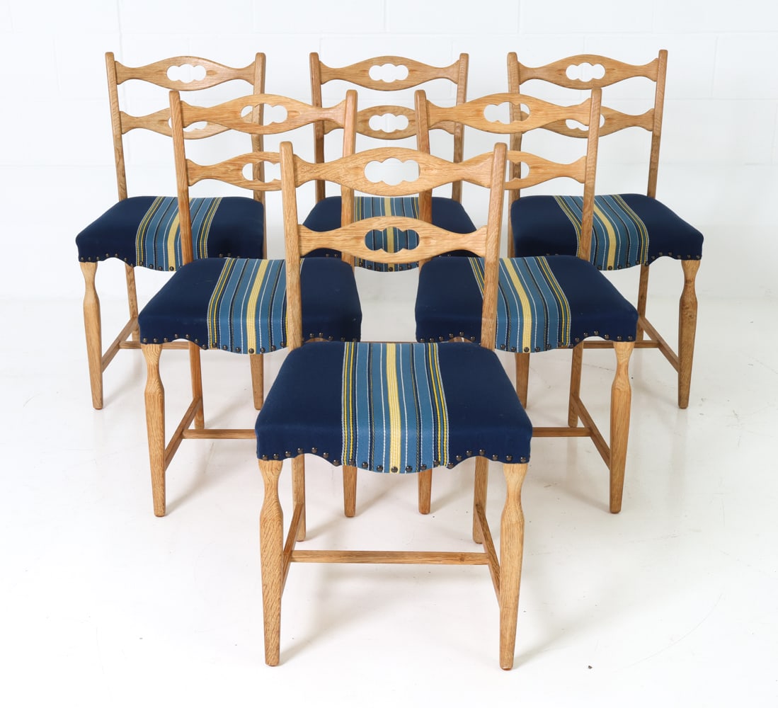 (6) ATTR. HENNING KJAERNULF OAK DINING CHAIRS: Six dining chairs featuring cut out backrest design and striped pattern upholstery. Denmark, circa 1970's. Dimensions: H 33" x W 18" x D 18" x SH 18" Condition: Very light signs of use to upholstery,