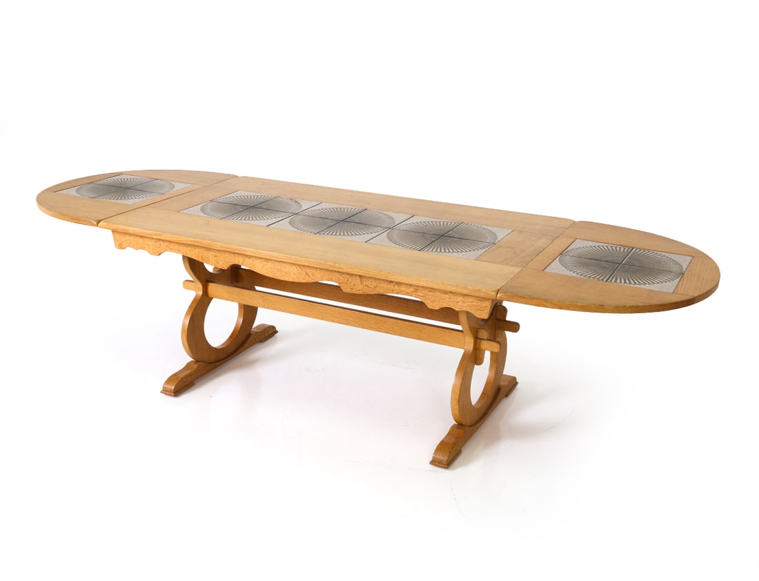 DANISH OAK & TILE EXTENDING DINING TABLE C. 1970S: Dining table with inlaid tiles and two drop leaves. Denmark, circa 1970's Dimensions: H 28" x W 61" x D 35.5" (Leaf 22.75") Condition: Couple of small spots of soiling to one edge. Few minor nicks and