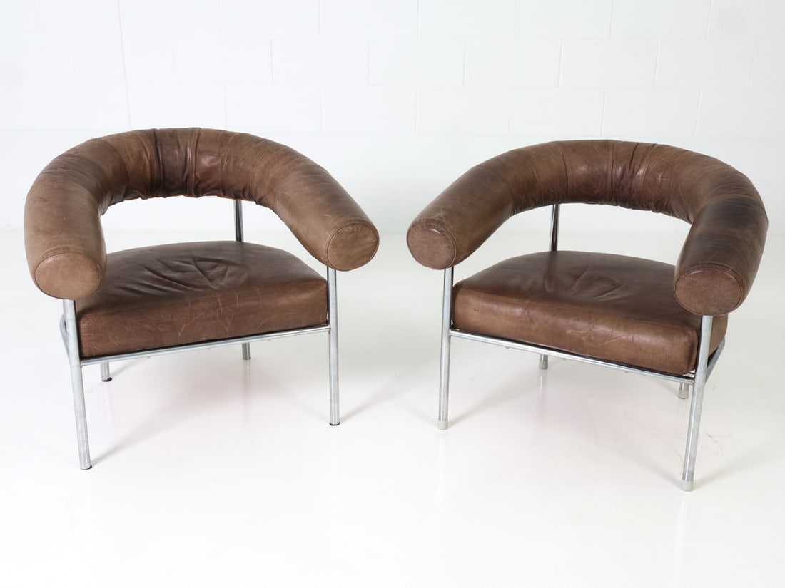 PAIR OF DE SEDE LEATHER & CHROME ARMCHAIR C. 1970S: Rare pair of armchairs with tubular chrome frames and brown leather cushions. Apparently unmarked. Swiss, circa 1970s. Dimensions: H 28" x W 32" x D 31" x Sh 15.5" Conditions: Wear consistent with age