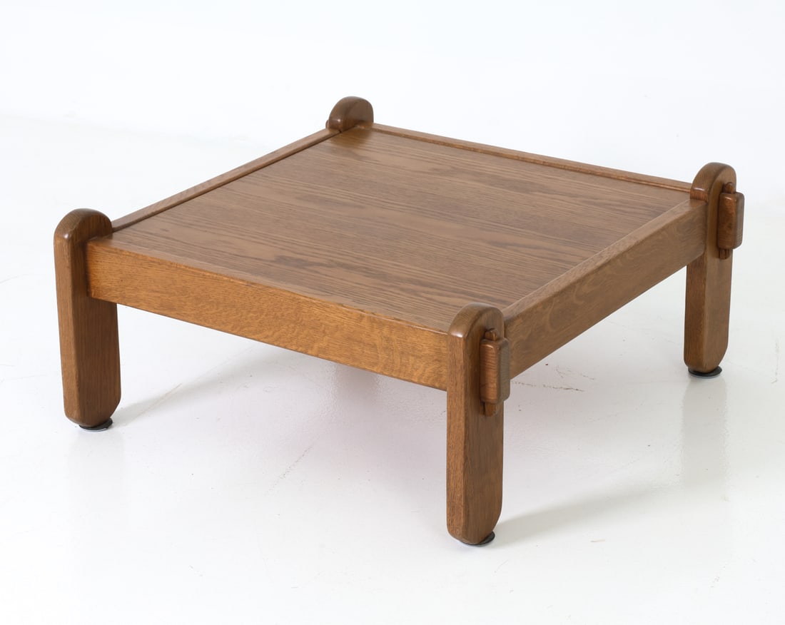 SWEDISH OAK COFFEE TABLE C. 1970S: Stained oak coffee table with thick legs. Sweden, circa 1970's. Dimensions: H 13.5" x W 30.5" x D 31" Condition: Minor scuffs and nicks with signs of use to legs. Wear consistent with age and use. 117