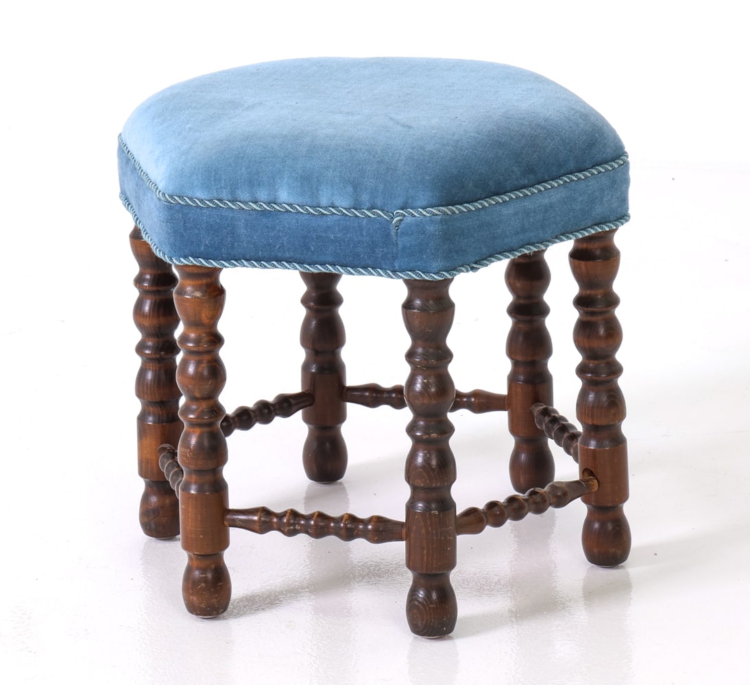 DANISH TURNED OAK & VELOUR STOOL C. 1940S: Barley twist legs and hexagonal shape. Blue upholstered cushion with a cord trim. Denmark, circa 1940s. Dimensions: H 15" x W 16" x D 16" Condition: Scuffs and nicks to legs with one small stress crac