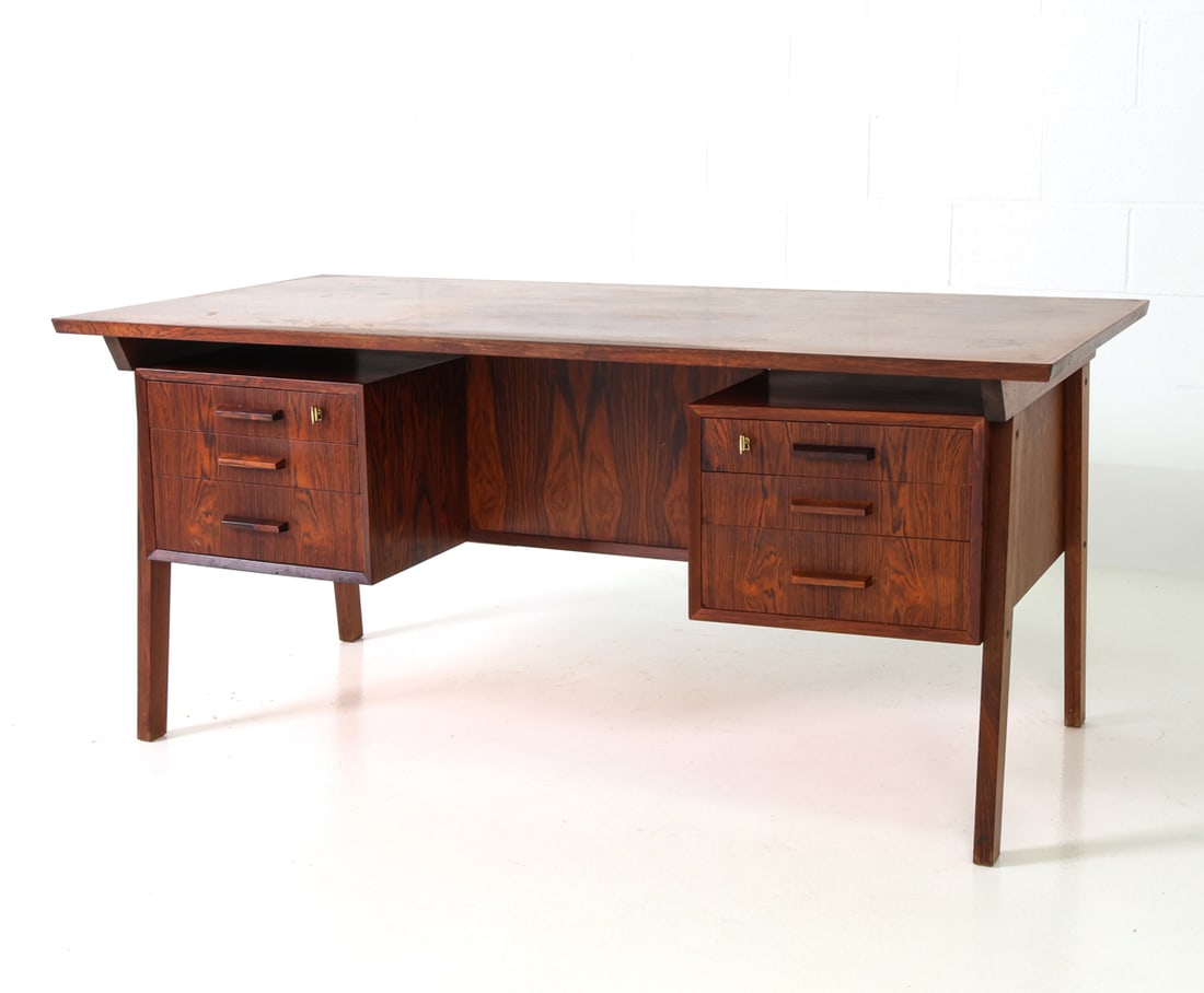 ARNE VODDER STYLE DANISH ROSEWOOD DESK C. 1960S: Rosewood desk featuring six drawers, two of which are lockable and an open compartment of the opposite side. Includes (2) keys. Denmark, circa 1960s. Dimensions: H 28.25" x W 63" x D 31.5" Condition: