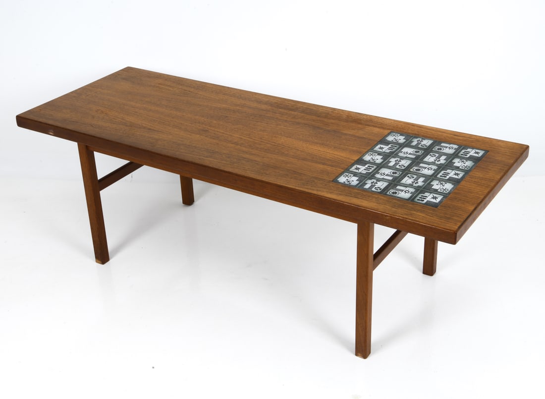 DANISH TEAK & CERAMIC TILE COFFEE TABLE C. 1970S: Teak frame with inlayed tile top. Denmark, circa 1970s. Dimensions: H 19.75" x W 59" x D 21.75" Condition: Wear consistent with age and use, including minor scratches and rubs to top and legs. G138