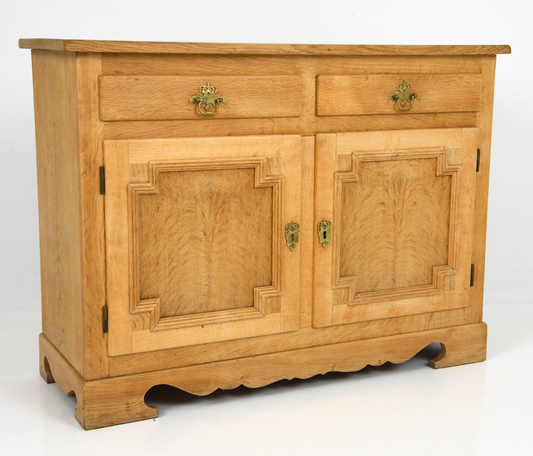 HENNING KJAERNULF STYLE DANISH OAK CABINET C.1970S: Oak cabinet featuring two drawers at top with interior space below for a shelf, with brass hardware. Key Included. Denmark, circa 1970s. Dimensions: H 30.75" x W 41.75" x D 16" Condition: Two stress c