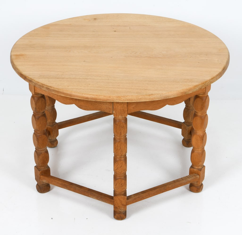 HENNING KJAERNULF STYLE DANISH OAK COFFEE TABLE: Round oak coffee with sculpted and turned legs. Denmark, circa 1960s. Dimensions: H 21" x Dia. 32.5" Condition: Wear consistent with age and use including naturally forming stress cracks to top.