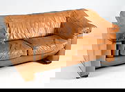 DE SEDE STYLE DANISH LEATHER LOVESEAT C. 1960S: Cognac leather sofa with beech feet. Denmark, circa 1960s. Dimensions: H 34.75" x W 65.5" x D 38" x Sh 18.25". Condition: Wear consistent with age and use including minor rubs and scuffs. Slight fadin