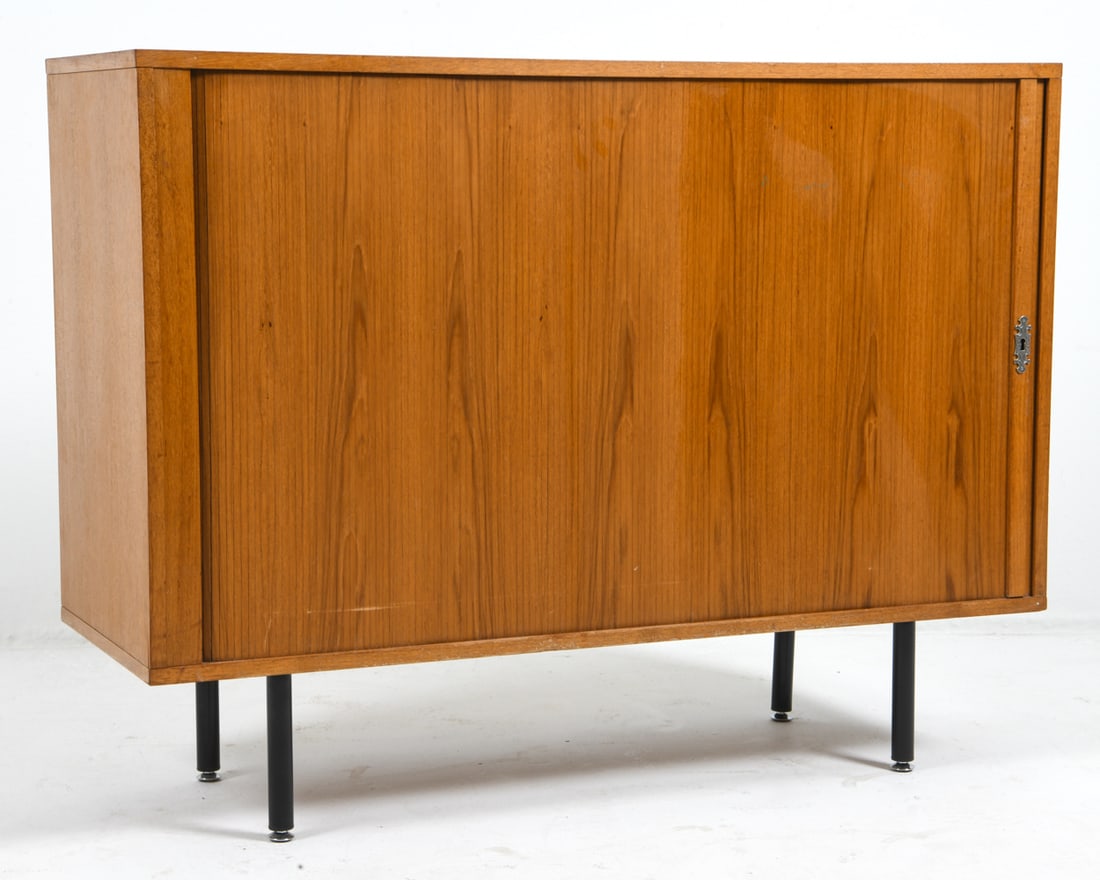NIPU DANISH TEAK TAMBOUR CABINET C. 1970S: Removable shelves. Apparently unmarked. Denmark, circa 1970s. Dimensions: H 37" x W 47" x D 18". Condition: No key. Some Scuffs and Scratches to top surface. Hole cut-out into back. Wear consistent wi
