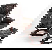 EKORNES STRESSLESS LEATHER LOUNGE CHAIR & OTTOMAN: Beech frame with brown leather upholstery. Branded to reclining adjustment knob. Norway, circa 1970s. Dimensions: H 39" x W 31" x D 28" x SH 18". Ottoman H 16" x W 19? x D 16?. Condition: Wear