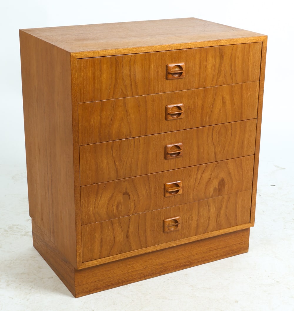 ATTR. DOMINO DANISH TEAK CHEST OF DRAWERS C. 1970S: Teak chest of drawers with rounded molded inset drawer pulls. Denmark, circa 1970s. Dimensions: H 27.75" x W 23.75" x D 15.75". Conditions: Wear consistent with age and use including dings and rubs,