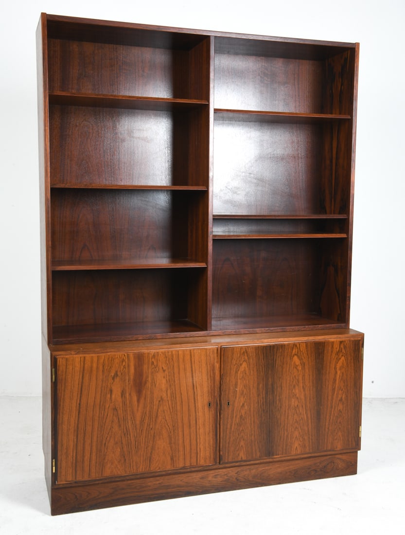 CARLO JENSEN FOR HUNDEVAD DANISH ROSEWOOD BOOKCASE: Key included. Top sits freely on base. Adjustable shelves. Apparently unmarked. Denmark, circa 1960s. Dimensions: H 77" x W 54.5" x D 16.75". Condition: Wear consistent with age and use including