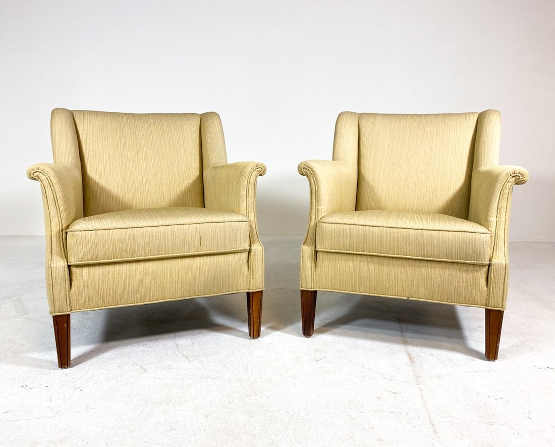 PAIR OF DANISH BEECH LOUNGE CHAIRS C. 1970S: Cream colored upholstery with beech legs. Denmark, circa 1970s. Dimensions: H 31.5" x W 27.5" x D 27.5" x SH 17". Condition: Few tears and stains to fabric in corner of arms. Wear consistent with age
