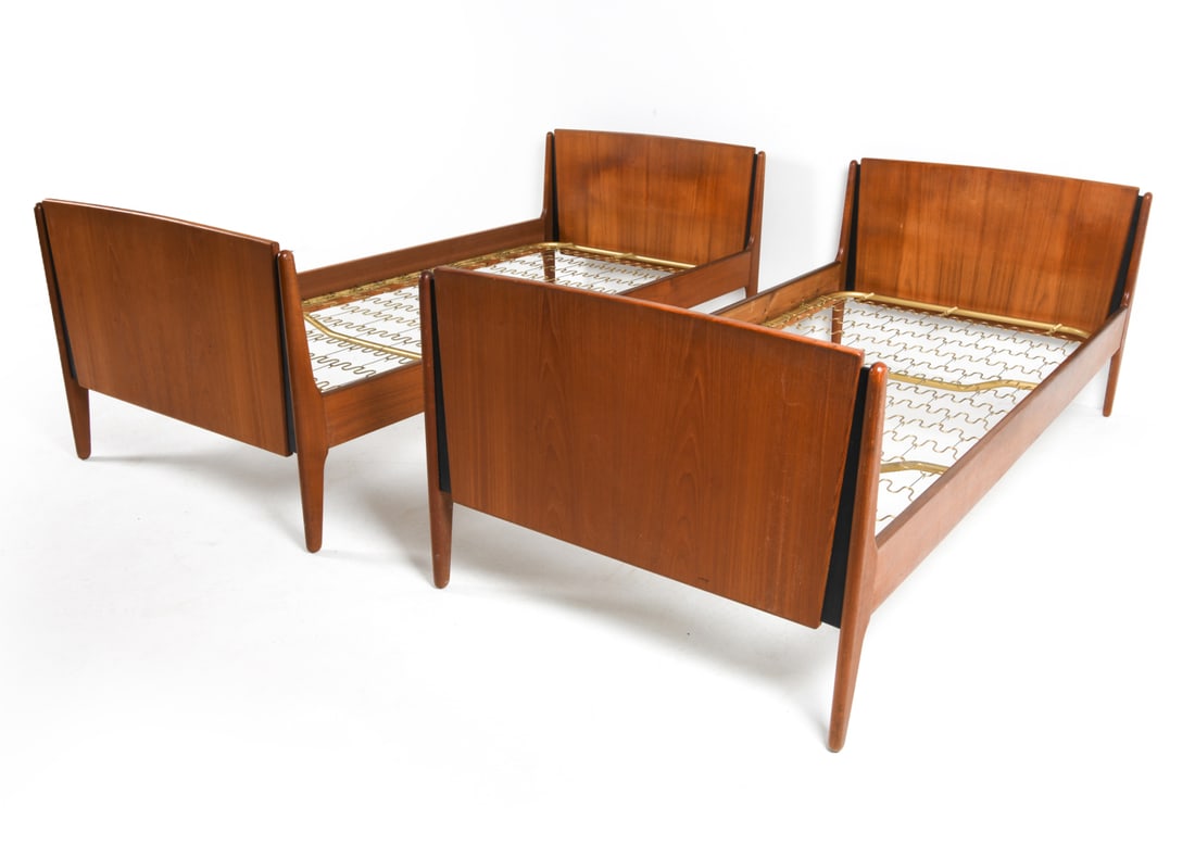 PAIR OF OMANN JUN STYLE TEAK TWIN BED FRAMES 1960S: Teak twin-sized bed frames. Denmark, circa 1960s. Dimensions: H 27" x W 36" x D 77" Interior: W 34" x L 75". Condition: Minor scratches and scuffs. Wear consistent with age and use.
