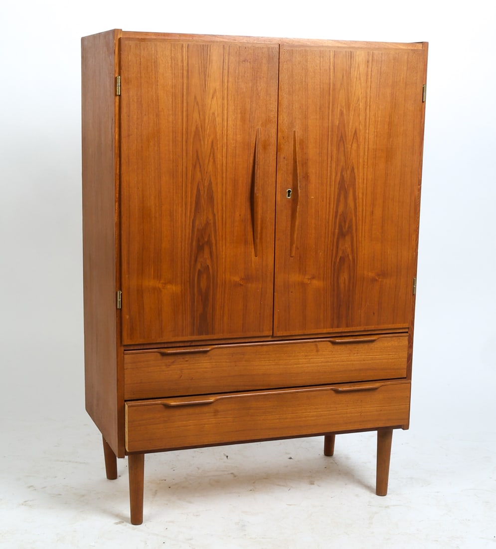 DANISH TEAK CABINET C. 1960S: Key Included. Large compartment with shelves and two drawers. Denmark, circa 1960s. Dimensions: H 46.25" x W 30.75" x D 16" Condition: Wear consistent with age and use including faint dings and rubs.