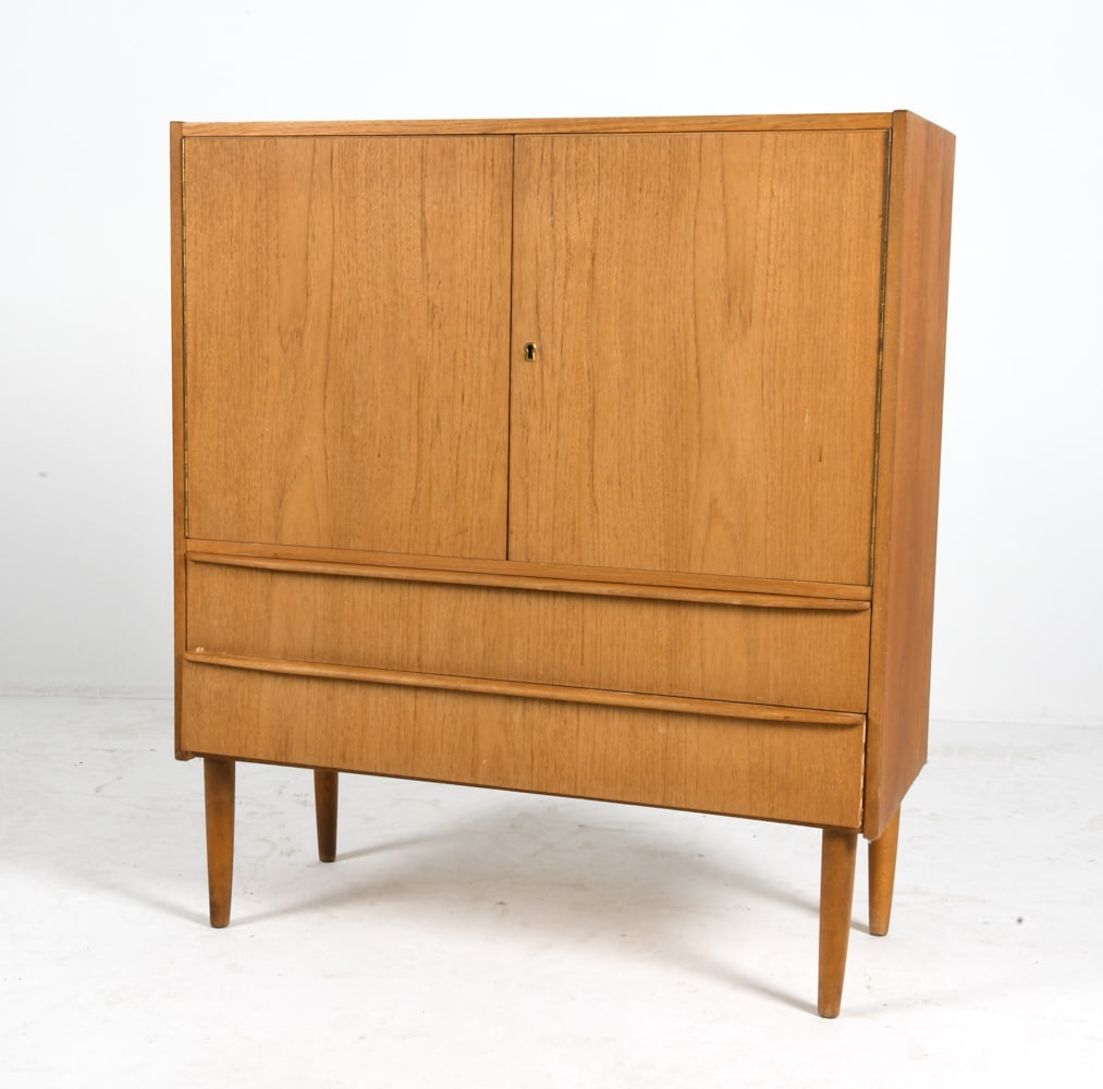 DANISH TEAK CABINET C. 1970S: Key Included. Adjustable shelves. Denmark, circa 1970s. Dimensions: H 40.5" x W 35.75" x D 15.5" Condition: Wear consistent with age and use, including rubs and scuffs, bottom drawer slightly warped.