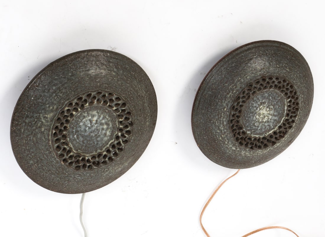 PAIR OF SCANDINAVIAN CERAMIC WALL SCONCES C. 1970S: Textured dark finish with perforated center pattern. Scandinavian, circa 1970s. Dimensions: Dia. 10.5" x Dia. 3". Condition: Wear consistent with age and use. Wiring untested. European plug.