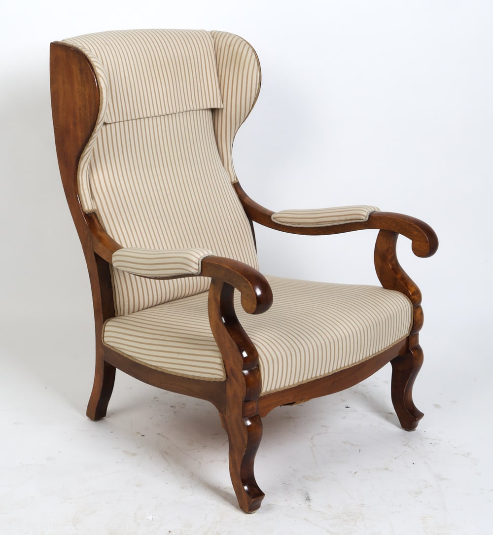 LARS MOLLER DANISH MAHOGANY WINGBACK LOUNGE CHAIR: Carved mahogany frame with beige wool upholstery. Tag to lower edge on frame. Denmark, circa 1960s. Dimensions: H 38.75" x W 22.75" x D 28.5" x Sh 14.5". Condition: Wear consistent with age and use