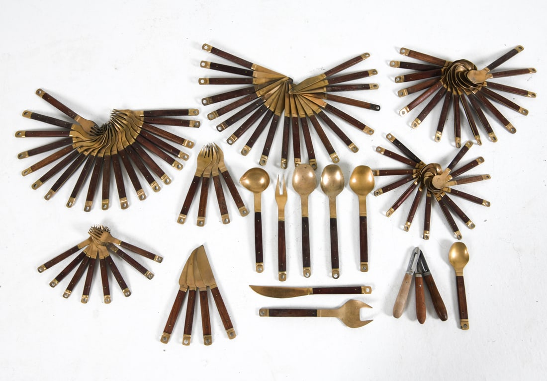 DANISH TEAK & BRASS FLATWARE GROUPING C. 1970S: Large grouping of flatware with teak handles. Denmark, circa 1970s. Dimensions: Longest L 10". Condition: Scuffs, scratches, and rubs to metal and wood. Wear consistent with age and use.