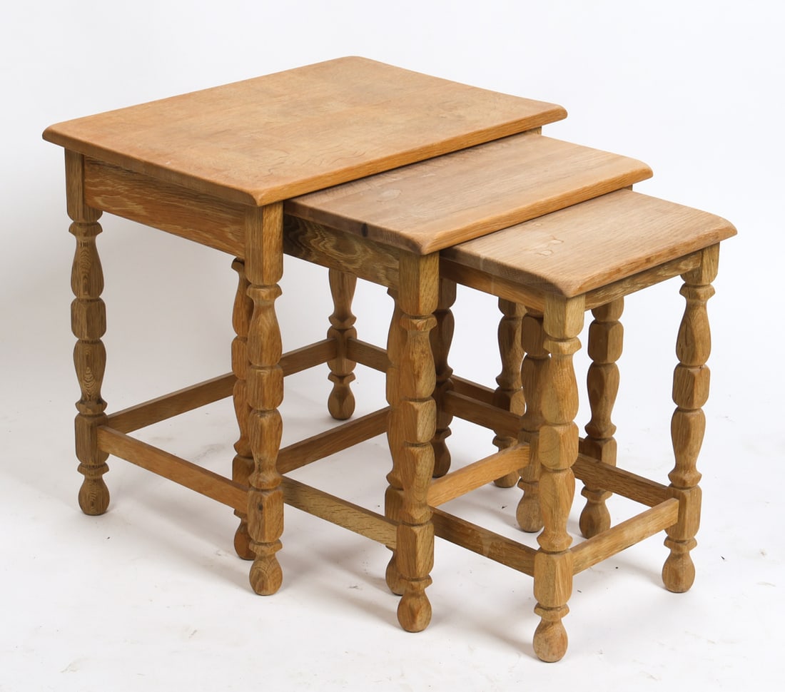 STYLE OF KJAERNULF DANISH OAK NESTING TABLES 1970S: Set of (3) oak nesting tables with turned legs. Denmark, circa 1970s. Dimensions: Largest H 20.5" x W 21" x D 15". Condition: Minor scuffs and scratches, wear consistent with age and use.