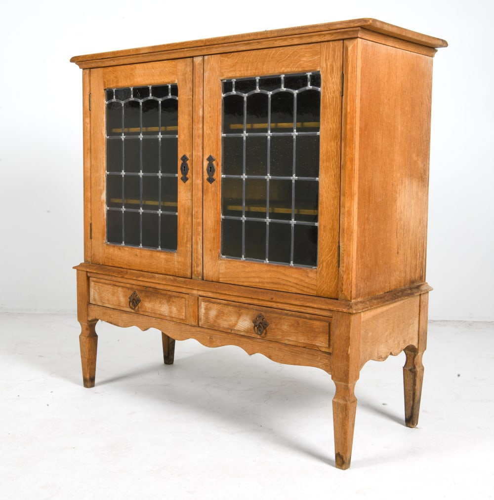 ATTR. HENNING KJAERNULF DANISH OAK CABINET C.1970S: Key included. Glass panels to cabinet doors. Brass drawer pulls. Adjustable shelves. Denmark, circa 1970s. Dimensions: H 43" x W 42" x D 17". Condition: Lock to one cabinet door needs maintenance.