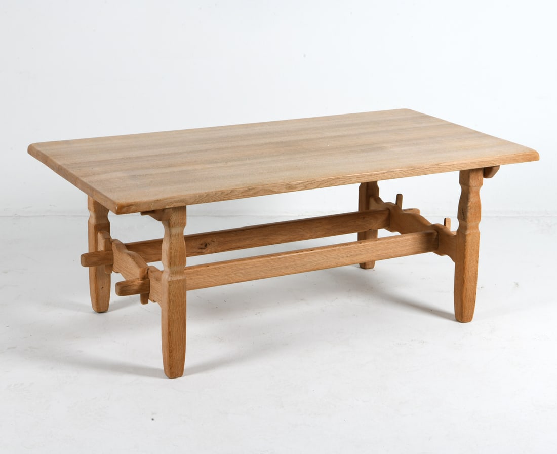 KJAERNULF STYLE DANISH OAK COFFEE TABLE C. 1970S: Turned legs with trestle style stretchers. Denmark, circa 1970s. Dimensions: H 22" x W 55" x D 29". Condition: Wear consistent with age and use. Minor scuffs and scratches, mostly to legs.